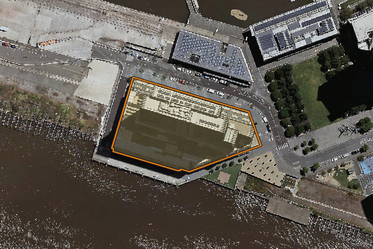 Aerial photo of 101/915 Collins Street, Docklands VIC 3008 with the lot boundary outlined in amber