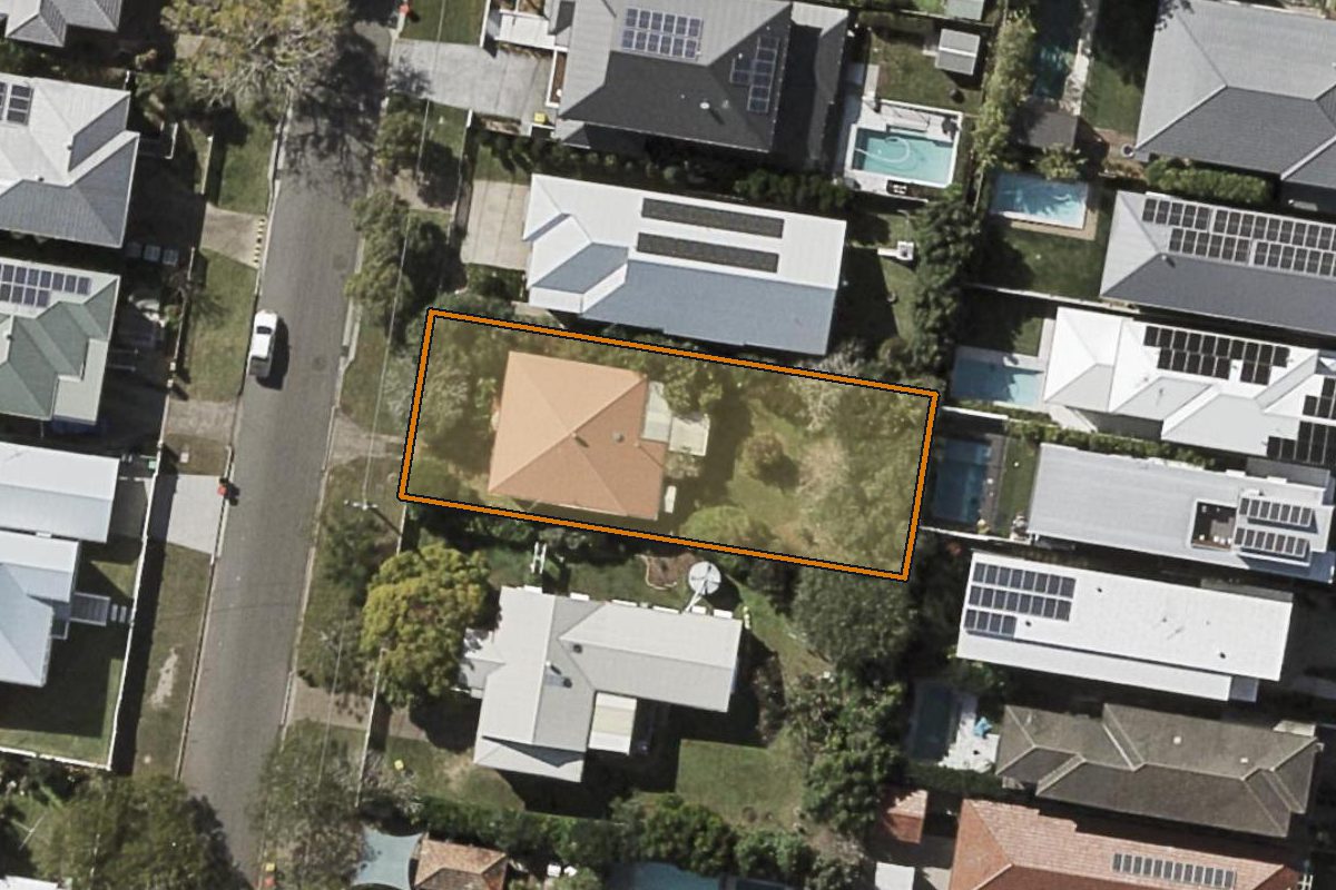 Aerial photo of 15 Palomar Parade, Wavell Heights QLD 4012 with the lot boundary outlined in amber