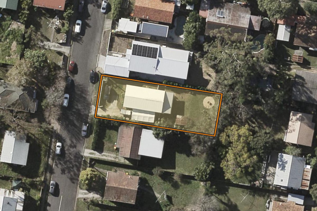 Aerial photo of 21 Kinnen Street, Enoggera QLD 4051 with the lot boundary outlined in amber