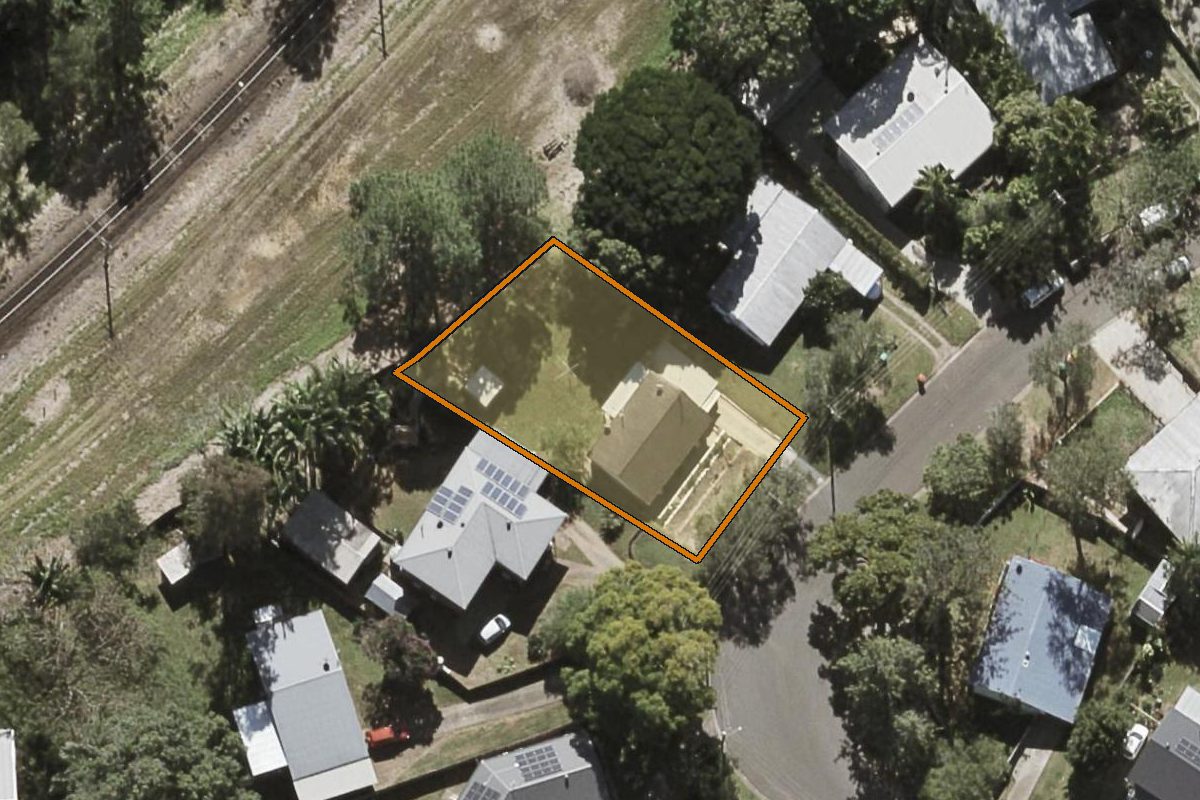 Aerial photo of 23 Holly Green Crescent, Palmwoods QLD 4555 with the lot boundary outlined in amber