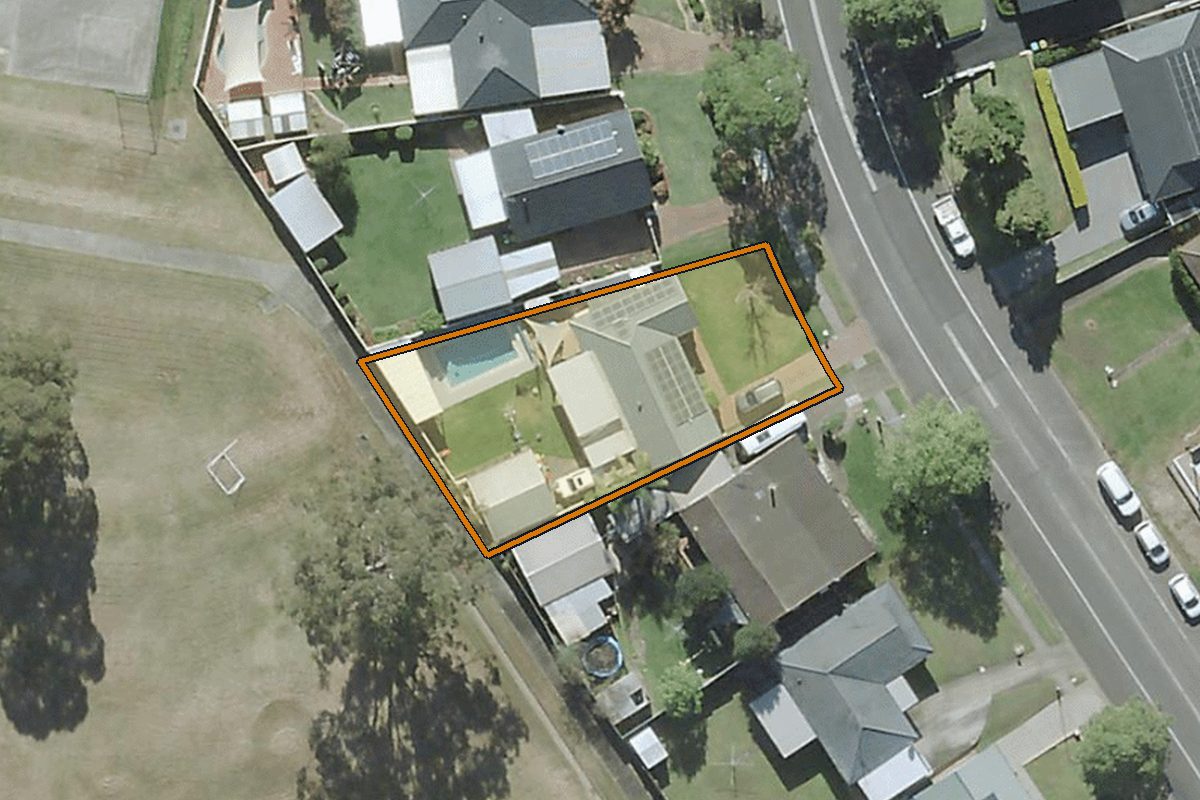 Aerial photo of 25 Henry Lawson Avenue, Werrington County NSW 2747 with the lot boundary outlined in amber