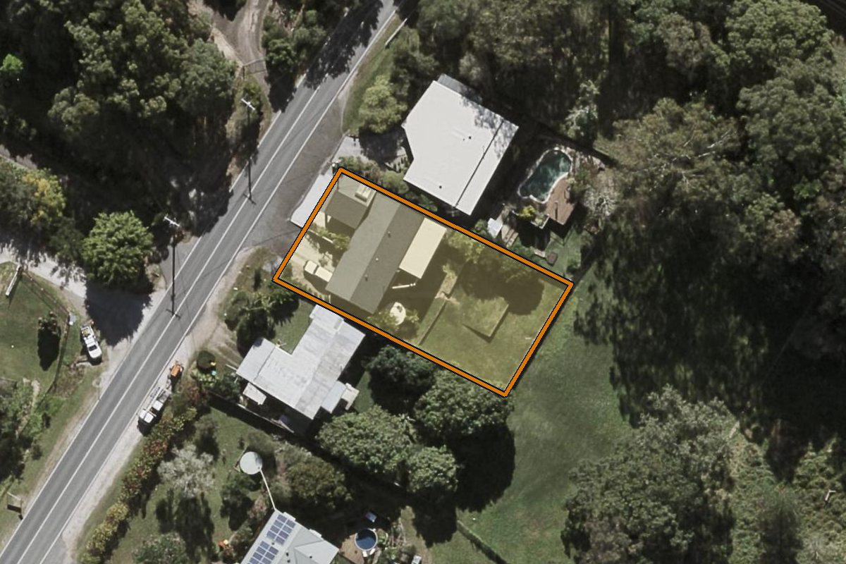 Aerial photo of 26 Kiel Mountain Road, Woombye QLD 4559 with the lot boundary outlined in amber