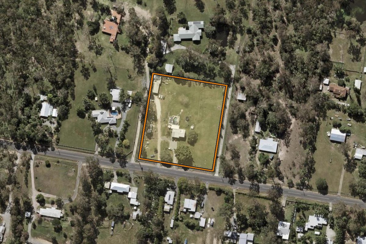 Aerial photo of 283-291 Stoney Camp Road, Greenbank QLD 4124 with the lot boundary outlined in amber