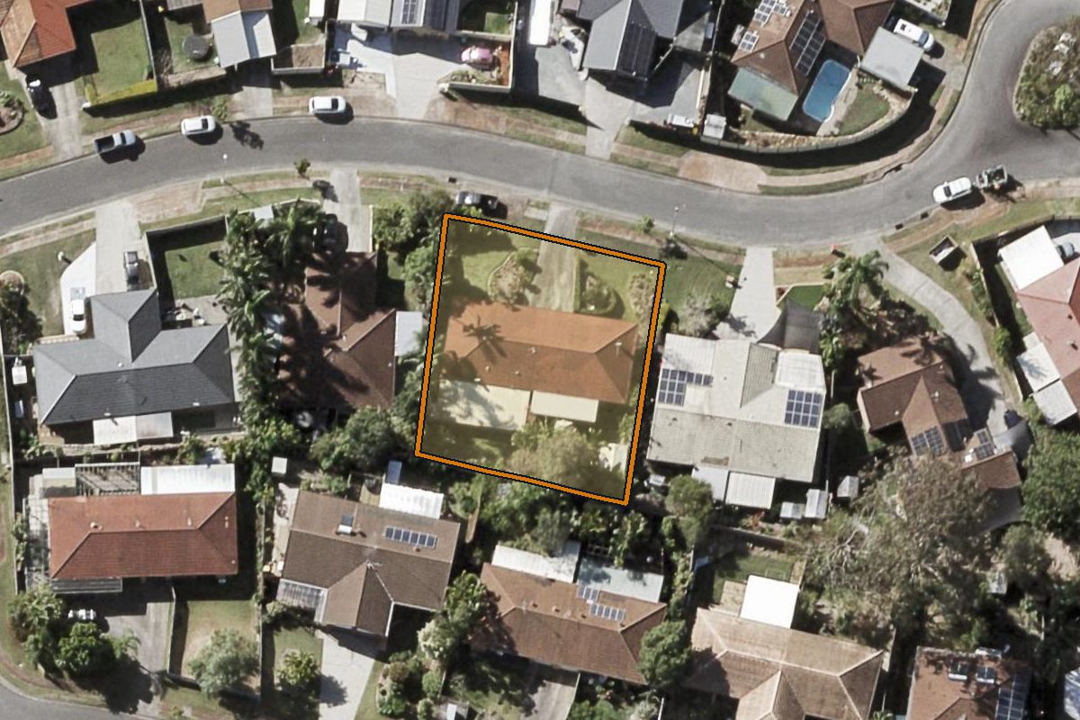 Aerial photo of 2/5 Columbia Court, Oxenford QLD 4210 with the lot boundary outlined in amber